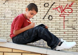 Kid writing a letter to Santa on rooftop