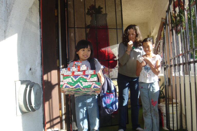 Little girl receiving gifts at Christmas