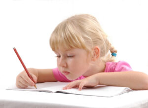 Girl in pink shirt writes a letter asking for free gifts from Santa