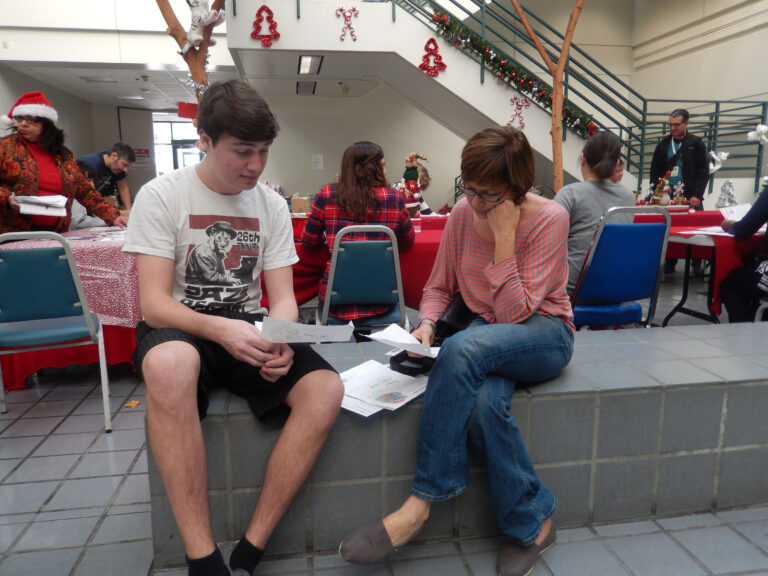 Woman and son volunteer to answer letters to Santa.