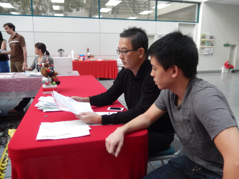 Man and his child volunteer to answer letters to Santa in Los Angeles.