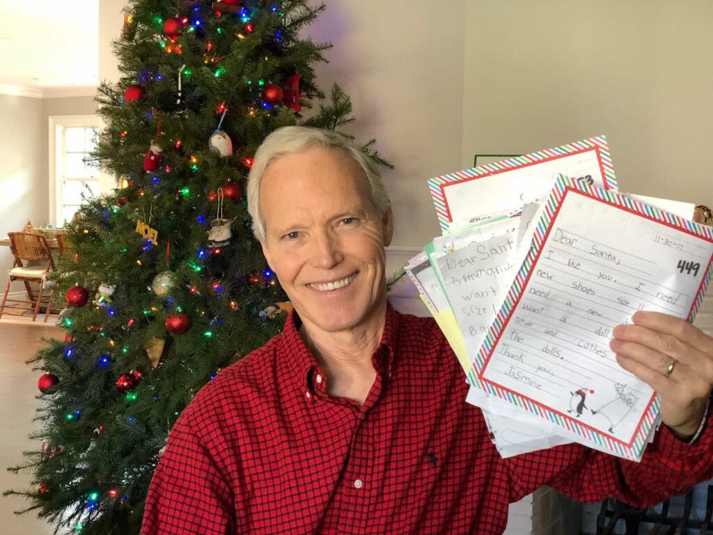 Elf in Chief - Elf Patrick Reynolds - holds real letters from children in need.