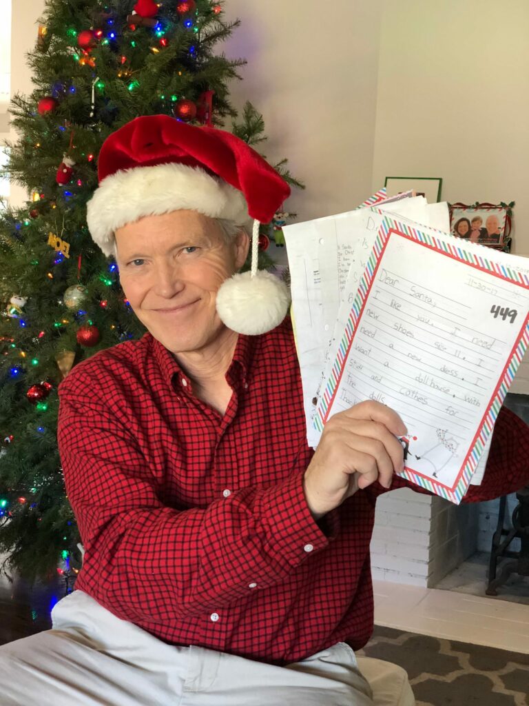 Patrick Reynolds proudly holds letters to Santa.